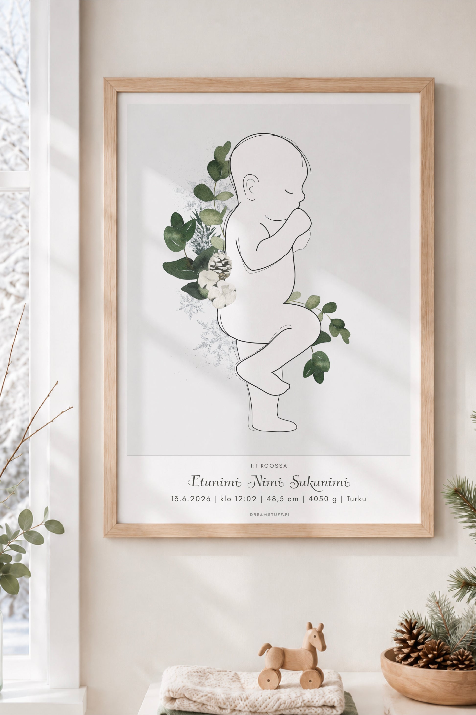 Personoitava talvisyntymäjuliste 1:1 kehystettynä vaaleassa skandinaavisessa lastenhuoneessa, vihreä talvikuvitus, luminen maisema ikkunasta.